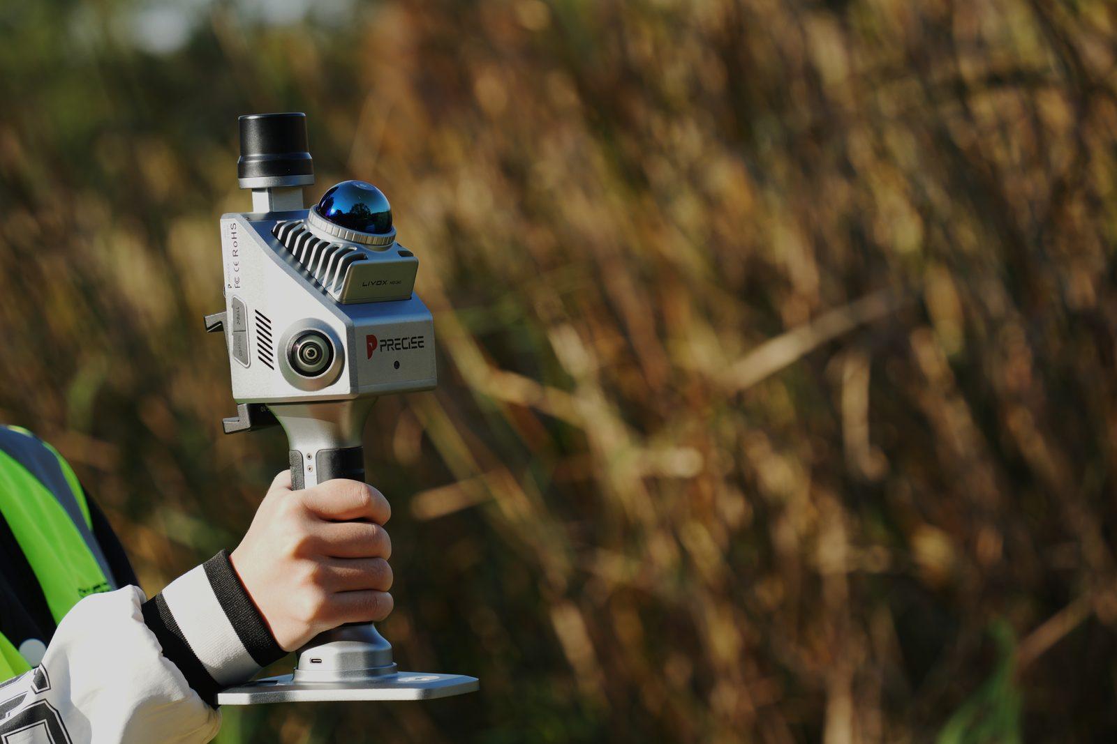 Surveyor holding PRECISE S2 in the field