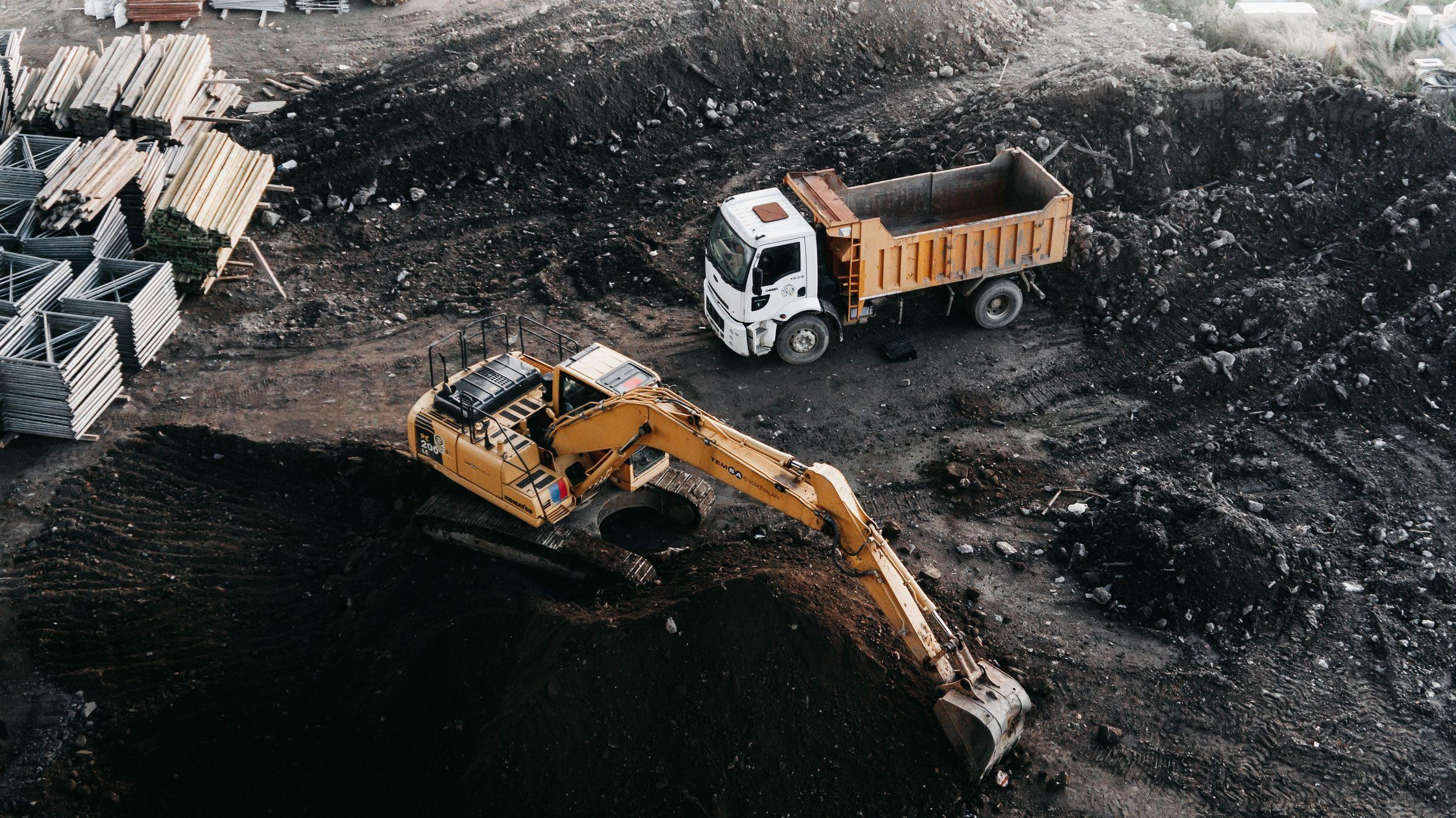 Excavator and dump truck working an active construction site