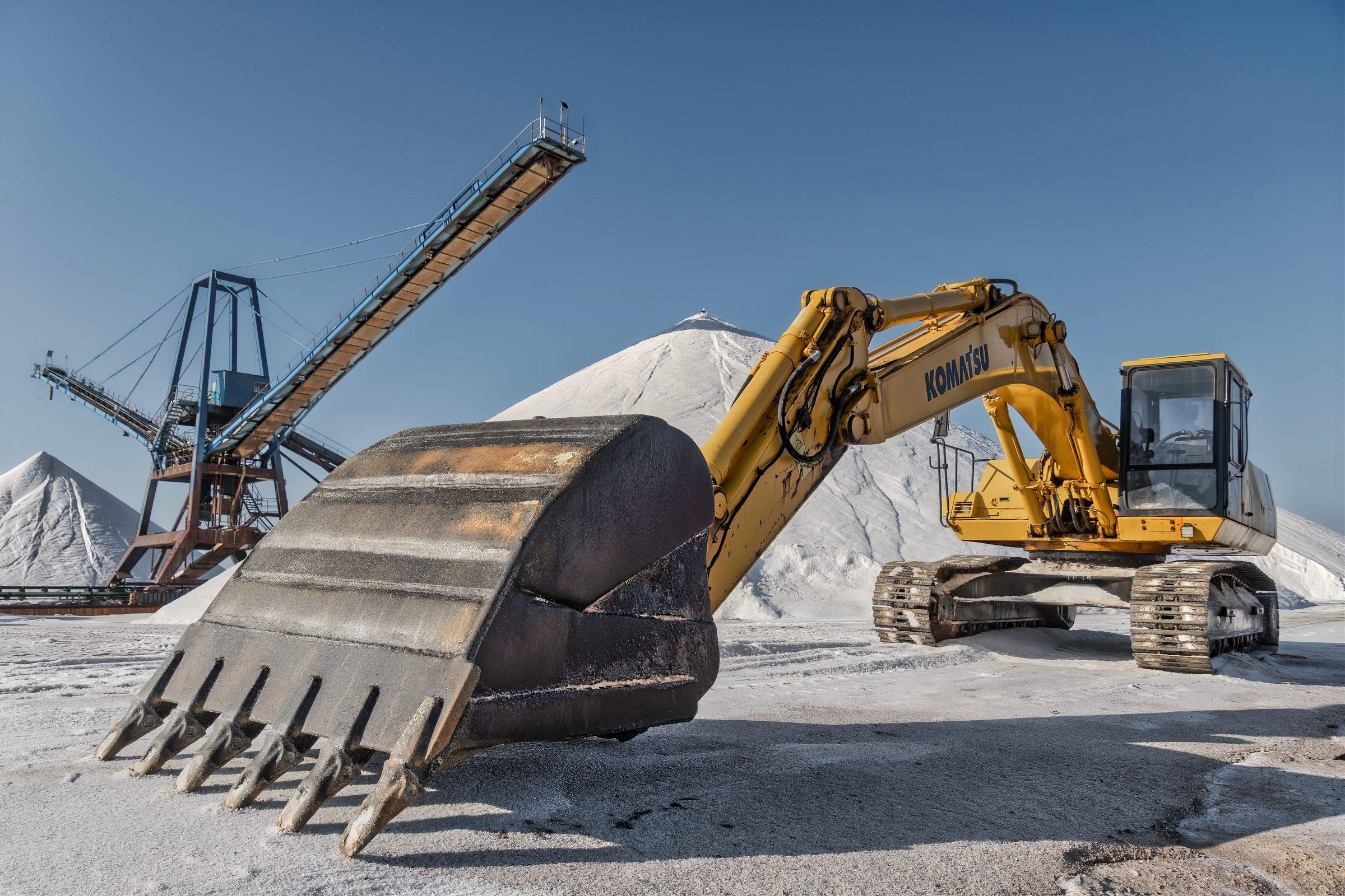Close-up of an excavator bucket's teeth on an industrial site