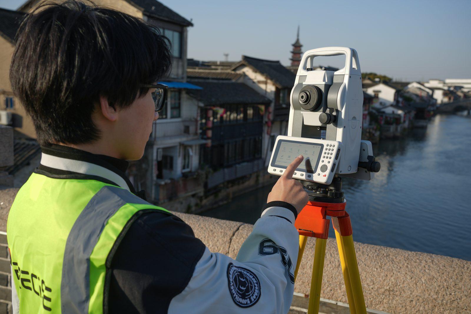 Surveyor operating T3's touchscreen on site